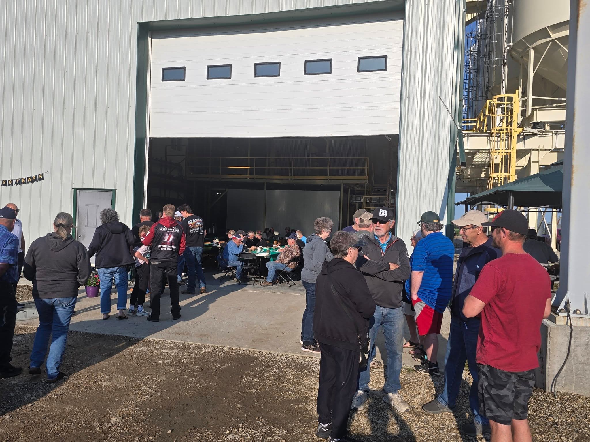 Guests gathered at the door of the new seed plant